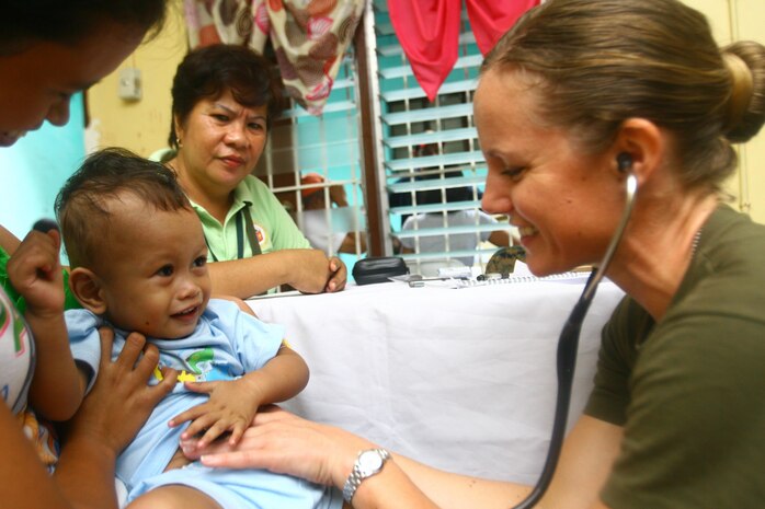 A young Philippine boy reacts as U.S. Navy Lt. Stephanie M. Ellis checks his vitals Sept. 26 during a cooperative health engagement at Bigaa Elementary School, Legazpi City, Albay, Philippines. Ellis is in the Philippines for Amphibious Landing Exercise 2014, a Philippine-U.S. exercise designed to improve interoperability, increase readiness and enhance the ability for a bilateral force to respond to natural disasters or other regional contingencies. She is with Combat Logistics Regiment 37, 3rd Marine Logistics Group, III Marine Expeditionary Force. 