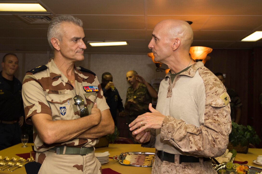 French Brig. Gen. Joel Rodes, French Forces Djibuoti commander, speaks with U.S Marine Col. Matthew G. St. Clair, 26th Marine Expeditionary Unit (MEU) commanding officer, in the flag mess of the USS Kearsarge (LHD 3), at sea, Sept. 30, 2013. The 26th MEU is a Marine Air-Ground Task Force forward-deployed to the U.S. 5th and 6th Fleet areas of responsibility aboard the Kearsarge Amphibious Ready Group serving as a sea-based, expeditionary crisis response force capable of conducting amphibious operations across the full range of military operations. (U.S. Marine Corps photo by Cpl. Kyle N. Runnels/Released)