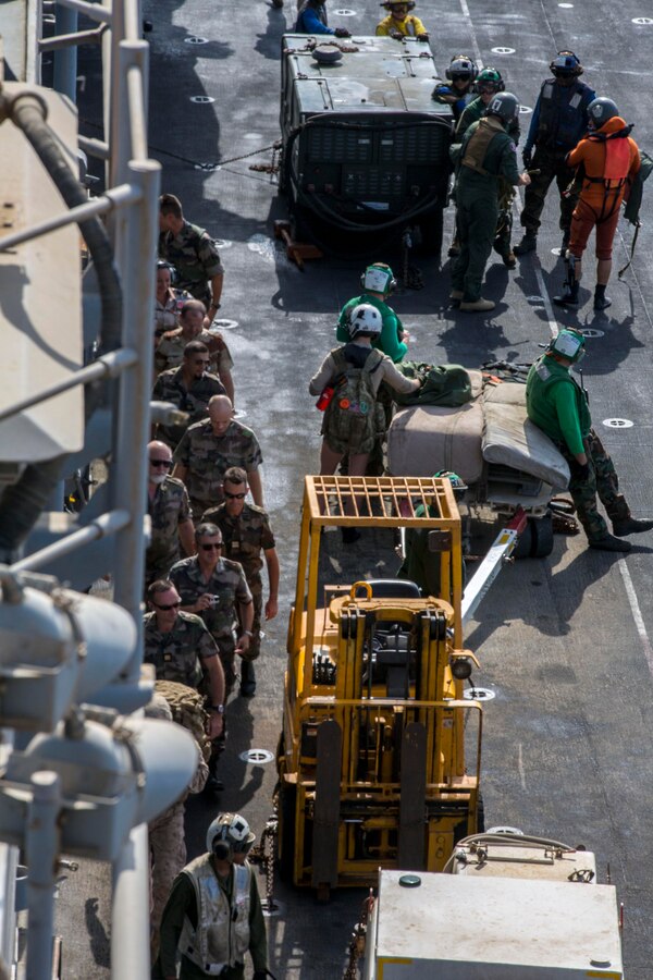 French Forces leadership from Djibouti, tour the USS Kearsarge (LHD 3), at sea, Sept. 30, 2013. The 26th Marine Expeditionary Unit (MEU) is a Marine Air-Ground Task Force forward-deployed to the U.S. 5th and 6th Fleet areas of responsibility aboard the Kearsarge Amphibious Ready Group serving as a sea-based, expeditionary crisis response force capable of conducting amphibious operations across the full range of military operations. (U.S. Marine Corps photo by Sgt. Christopher Q. Stone, 26th MEU Combat Camera/Released)