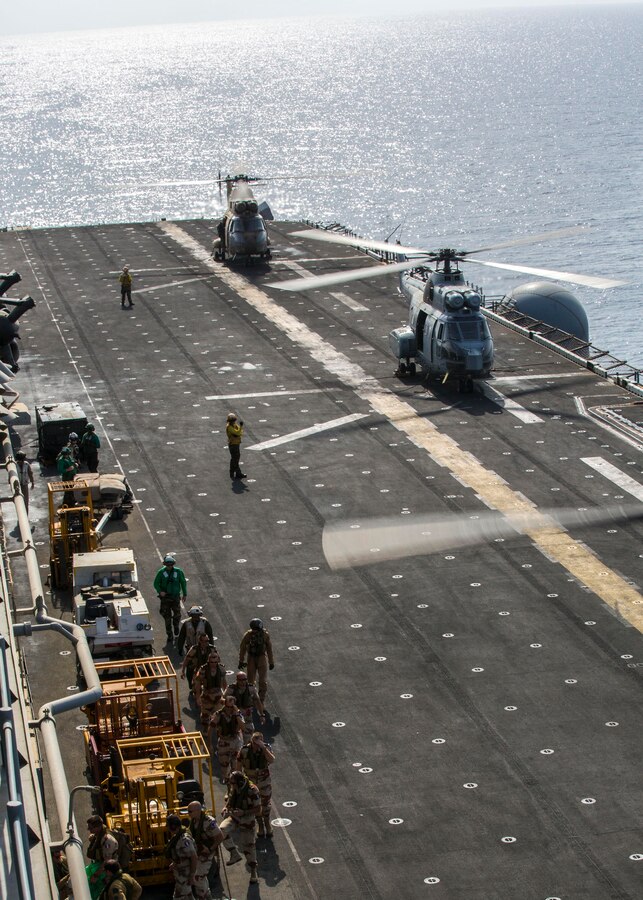 French Forces leadership from Djibouti, tour the USS Kearsarge (LHD 3), at sea, Sept. 30, 2013. The 26th Marine Expeditionary Unit (MEU) is a Marine Air-Ground Task Force forward-deployed to the U.S. 5th and 6th Fleet areas of responsibility aboard the Kearsarge Amphibious Ready Group serving as a sea-based, expeditionary crisis response force capable of conducting amphibious operations across the full range of military operations. (U.S. Marine Corps photo by Sgt. Christopher Q. Stone, 26th MEU Combat Camera/Released)