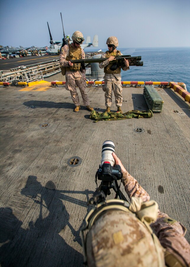 U.S. Marine Corps Cpl. Kyle N. Runnels, 26th Marine Expeditionary Unit combat correspondent, records video of Marines assigned to Low Altitude Air Defense Platoon, Marine Medium Tiltrotor Squadron (VMM) 266 (Reinforced), 26th MEU, as they prepare to fire a Stinger Launch Simulator during familiarization training aboard the USS Kearsarge (LHD 3), at sea, Oct. 2, 2013. The Stinger Launch Simulator mimics the launching procedure of the Stinger Weapon System; both are alternately fired on an annual basis. The 26th MEU is a Marine Air-Ground Task Force forward-deployed to the U.S. 5th and 6th Fleet areas of responsibility aboard the Kearsarge Amphibious Ready Group serving as a sea-based, expeditionary crisis response force capable of conducting amphibious operations across the full range of military operations. (U.S. Marine Corps photo by Sgt. Christopher Q. Stone, 26th MEU Combat Camera/Released)
