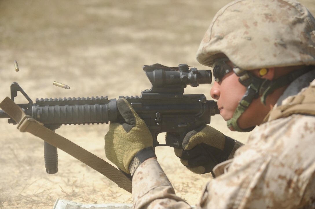 Cpl. Ivan Gonzalezaerrea, 21,TBS warfighting division, Edinburg, Texas, fires down range at a T-40 Marathon Robot during a Moving Target Engagement exercise at Range 12 aboard Marine Corps Base Quantico on Sept. 20, 2013. The weapons Marines will be firing during the exercise are: the 5.56 mm semiautomatic rifle, an M-16 service rifle and the Heckler-Koch M27 infantry automatic rifle.