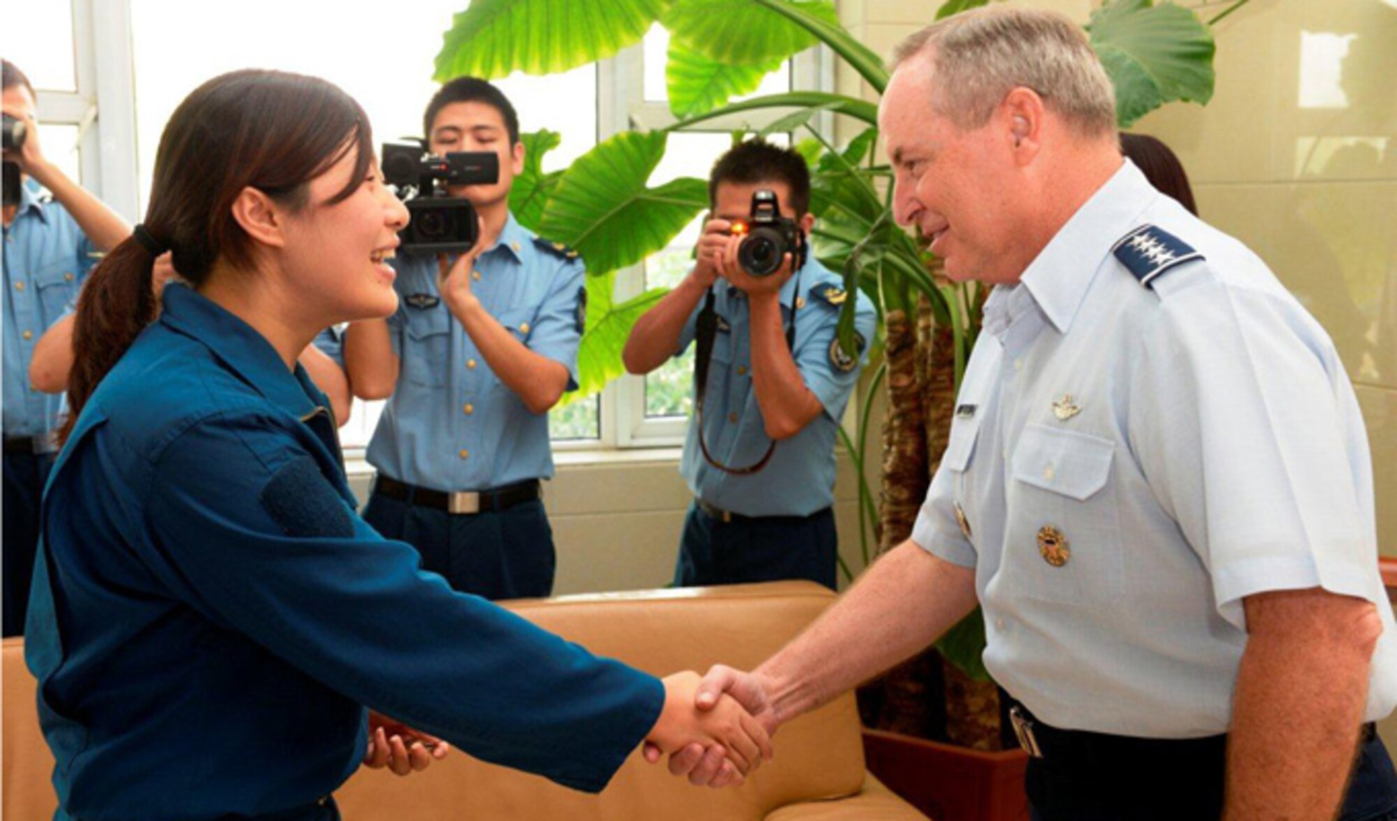 Air Force Chief of Staff Gen. Mark A. Welsh III greets a pilot from the People's Liberation Army Air Force Sept. 27, 2013, at Nanyuan Air Base, China. Welsh, along with Gen. "Hawk" Carlisle and Chief Master Sgt. of the Air Force James A. Cody, visited with various military leaders as part of a weeklong visit to China.