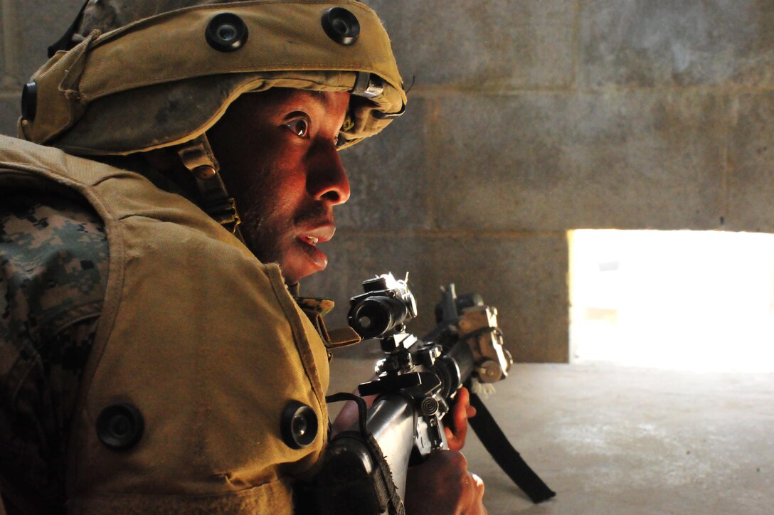 Second Lt. David Hunter looks for an opponent during a training exercise at the Military Operations Urban Terrain Town at Marine Corps Base Quantico on Sept. 25, 2013. Almost 300 Charlie Co. Marines participated in the event.