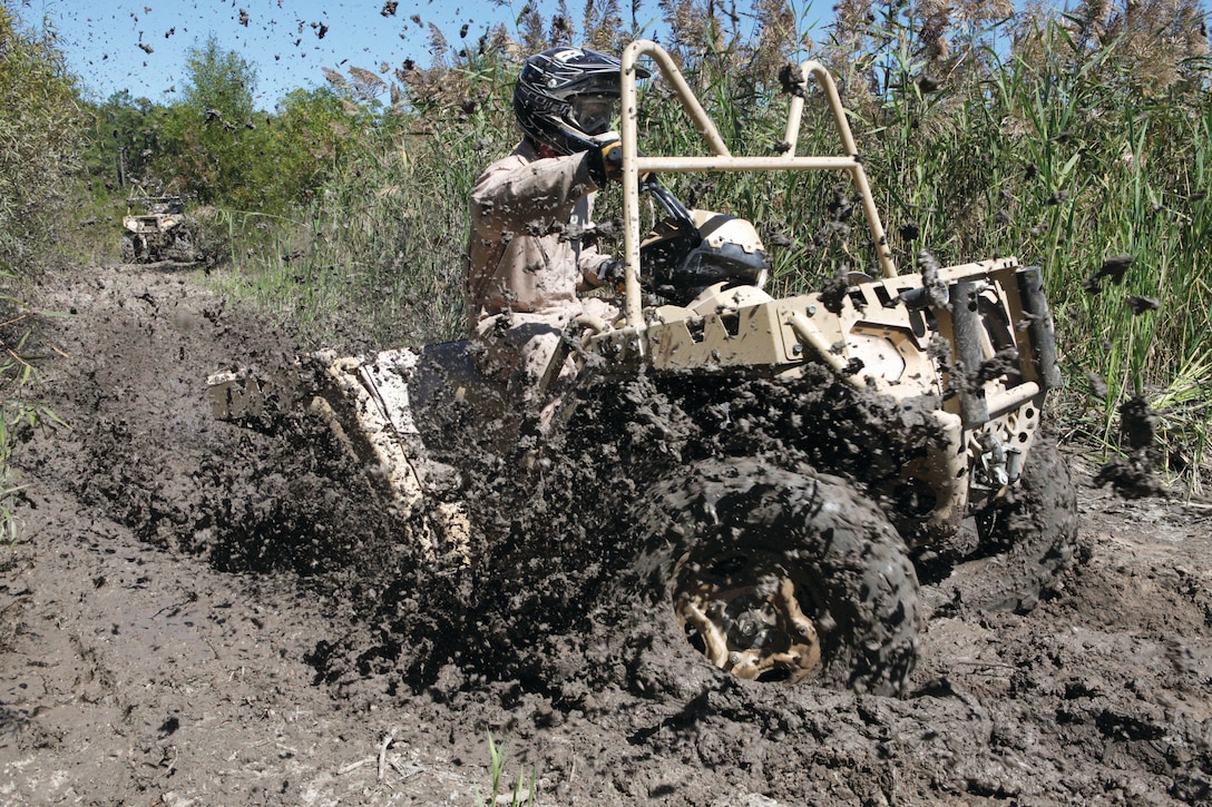 A Marine from 2nd Marine Special Operations Battalion drives his all-terrain vehicle through the mud during the ATV training course aboard Marine Corps Base Camp Lejeune, Sept. 19.