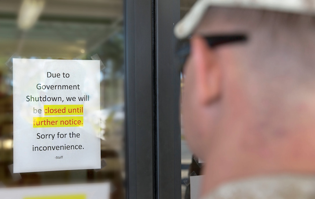 Service members are greeted by locked doors at the Harriotte B. Smith library aboard Marine Corps Base Camp Lejeune due to a government shutdown, Oct. 1. Only operations and activities essential to safety, protection of human life and protection of our national security are authorized to remain open, and only the minimum number of civilian employees necessary to carry out those activities will be exempt from furlough.