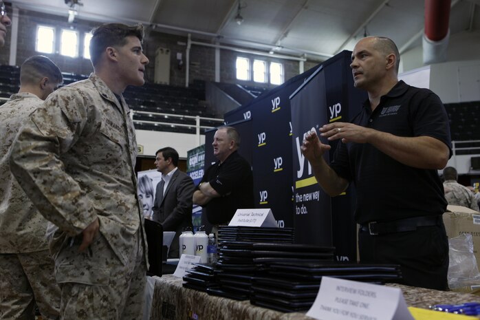 Cpl. Zachary D. Edwards, an infantrymen with 3rd Battalion, 6th Marine Regiment, talks with Jason Hejlik, a military adviser representative with Motorcycle and Marine Institute, about possible employment and education opportunities during the National Job Fair and Education Expo at the Goettge Memorial Field House aboard Marine Corps Base Camp Lejeune, Sept. 25.