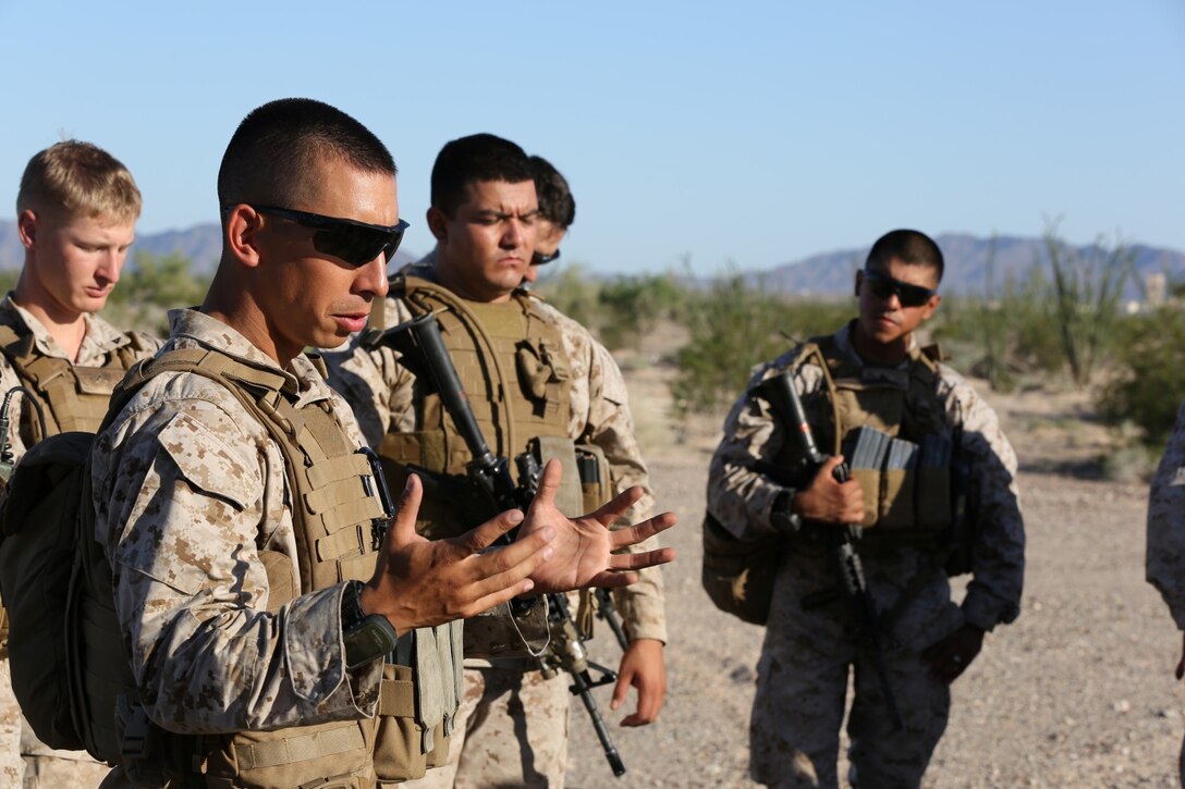 Sergeant Michael Nibler, a squad leader serving with Baker Company, 1st Battalion, 7th Marine Regiment, and a native of Seattle, debriefs his Marines after a training convoy here, Sept. 24, 2013. The Baker Co. Marines drove two Mine Resistant, Ambush Protected All Terrain Vehicles and two armored Humvees to a turnaround point nearly an hour away and then returned to their starting point. The training was designed to be a basic introduction for patrolling with vehicles