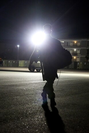 A Marine with 1st Battalion, 1st Marine Regiment, returns for an accountability formation as part of an air contingency battalion recall rehearsal aboard the Camp Horno parade deck here, Sept. 26, 2013. The drill required Marines to arrive in two hours at the parade deck and get accountability of their gear. The Marines of First of the First make up the air contingency battalion for the next 30 days and are ready to deploy anywhere in the world at anytime.