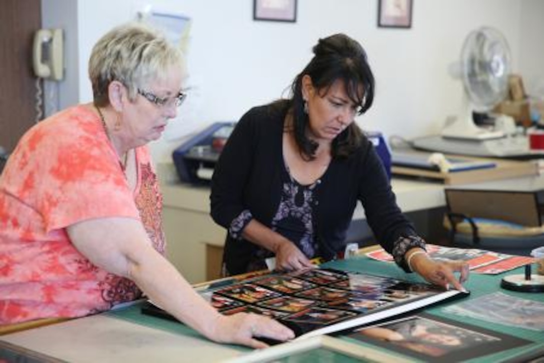 Joann Williams (right), fire prevention specialist on Marine Corps Logistics Base Barstow, Calif., works with Cheryle Magorno (left), graphics designer on base, at the public affairs office here, Sept 30. Williams has been working at the public affairs office as an assignment for the New Leadership Program she is participating in.



