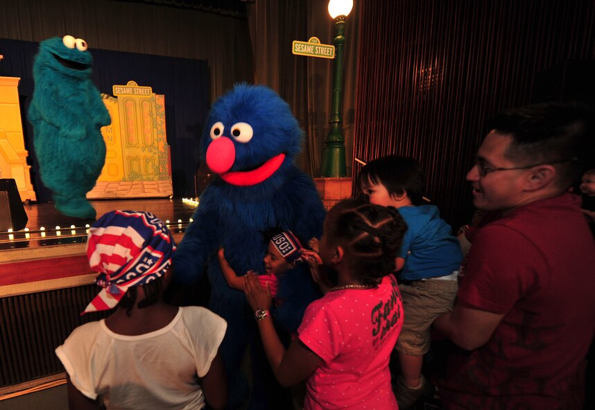 Grover greets children during The Sesame Street/USO Experience for Military Families on Kadena Air Base, Japan, Oct. 1, 2013. Since its debut in July 2008, the show has taken its message to more than 248,000 troops and military families and performed more than 433 shows on 131 military bases in 33 states and 11 countries. (U.S. Air Force photo by Staff Sgt. Rachelle Coleman)