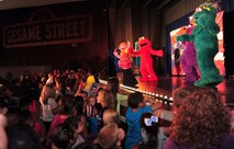 Characters from the Sesame Street television show sing and dance at the Keystone Theater on Kadena Air Base, Japan, Oct. 1, 2013. The United Services Orginazation teamed with the Sesame Workshop, the non-profit organization that produces Sesame Street, to bring the The Sesame Street/USO Experience for Military Families to the Asia-Pacific region. (U.S. Air Force photo by Staff Sgt. Rachelle Coleman)