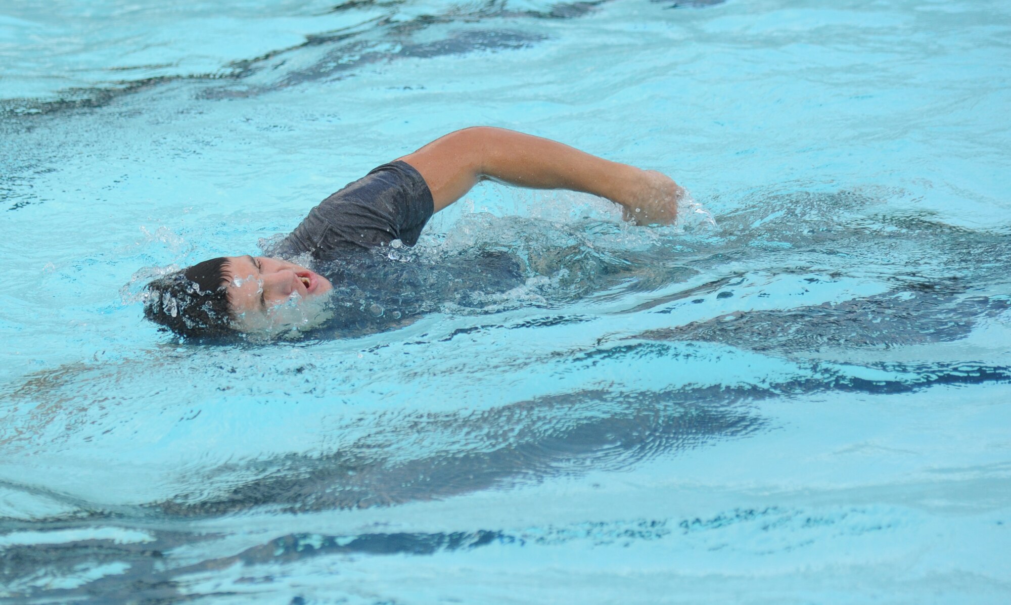 Airman Cody Ely, 334th Training Squadron combat controller student, swims freestyle laps at the triangle pool during a memorial physical training session with members of the 334th Training Squadron combat controllers and the 335th Training Squadron special operations weather team Sept. 27, 2013, at Keesler Air Force Base, Miss.  The PT event was in memory of combat controller Senior Airman Mark Forester who was killed in action on Sept. 29, 2010. (U.S. Air Force photo by Kemberly Groue)