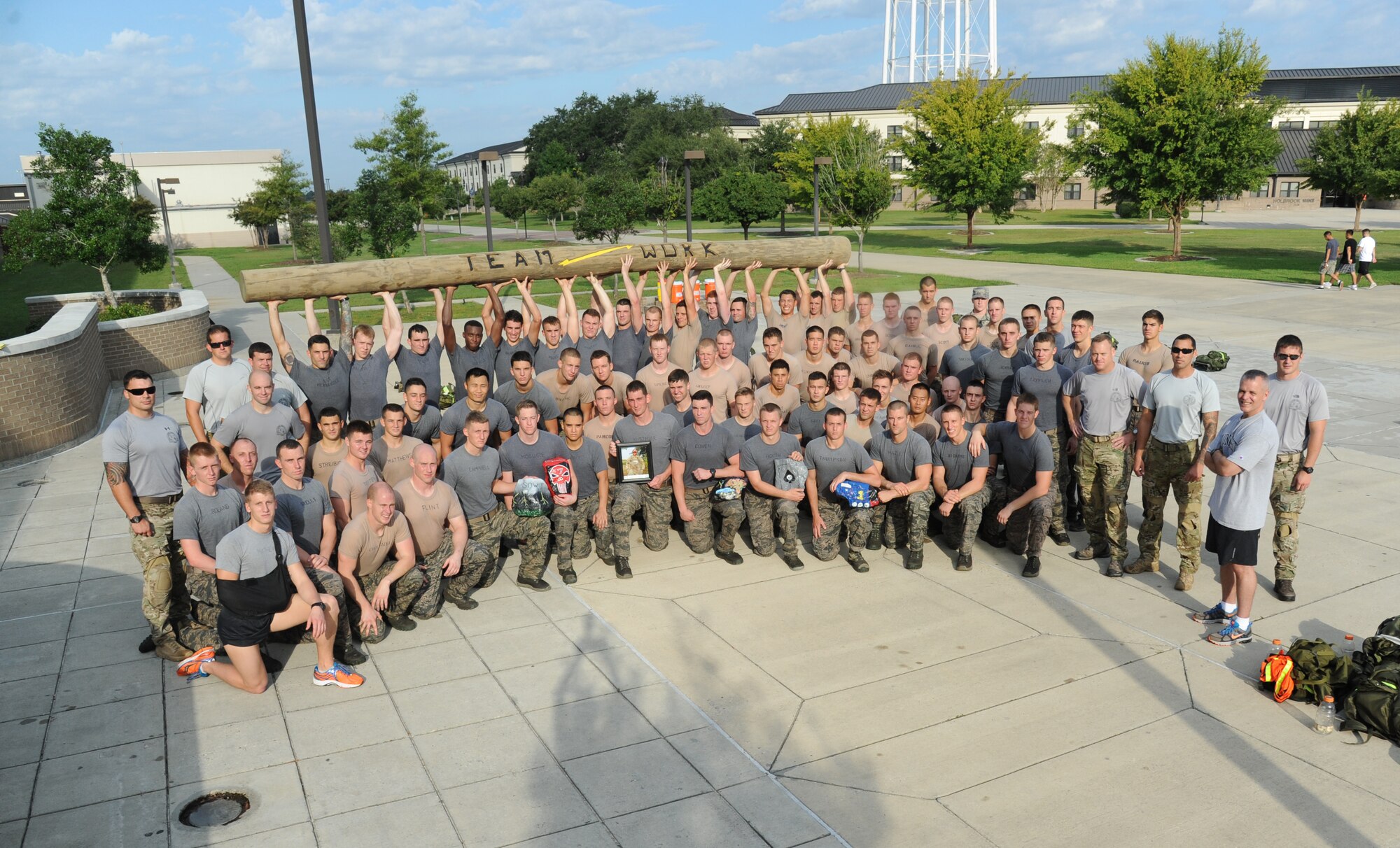Members of the 334th Training Squadron combat controllers and the 335th Training Squadron special operations weather team honor a fallen warrior with a memorial physical training session Sept. 27, 2013, at Keesler Air Force Base, Miss.  The PT event was in memory of combat controller Senior Airman Mark Forester who was killed in action on Sept. 29, 2010. (U.S. Air Force photo by Kemberly Groue)