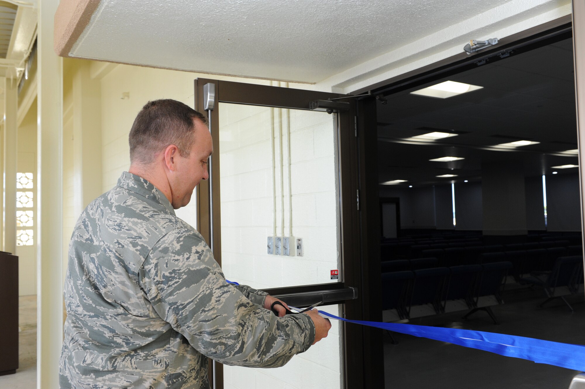 U.S. Air Force Lt. Col. Derek Stuart, 733rd Air Mobility Squadron commander, reopens the Kadena Passenger Terminal's Samurai Lounge at a ribbon cutting ceremony on Kadena Air Base, Japan, Oct. 1, 2013. The Samurai Lounge is used as a holding area for large amounts of passengers at the terminal prior to departure on various flights such as the Patriot Express. (U.S. Air Force photo by Airman 1st Class Hailey R. Davis)