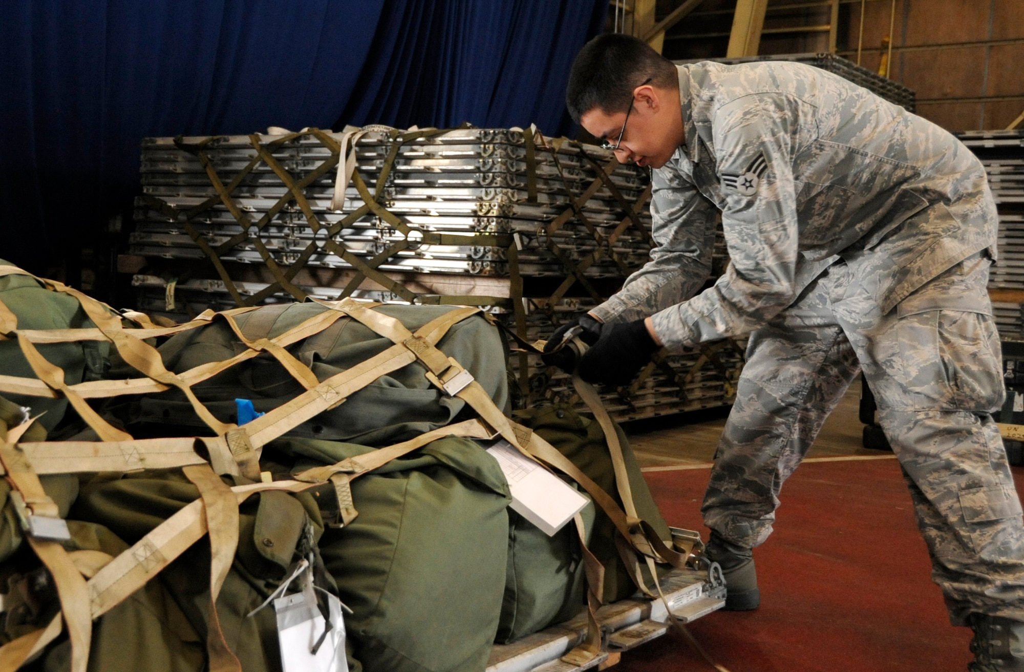 Senior Airman Nicholas Frias, 35th Aircraft Maintenance Squadron weapon systems journeyman, secures a pallet during an Operational Readiness Exercise at Misawa Air Base, Japan, Oct. 2, 2013. The purpose of an ORE is to test the 35th Fighter Wing’s ability to generate aircraft and deploy combat power worldwide. (U.S. Air Force photo by Airman 1st Class Kaleb Snay)