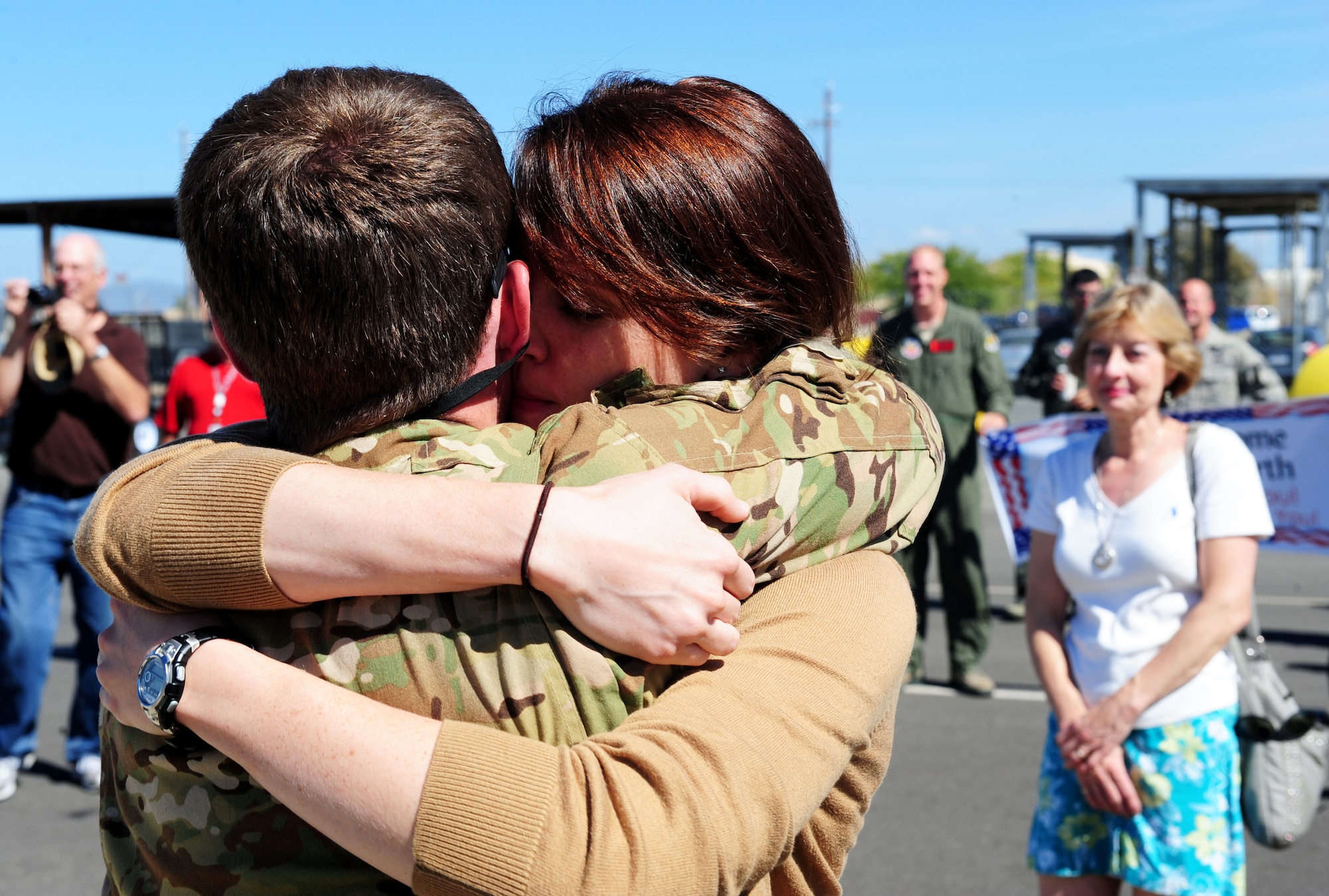 A recently returned MC-12W pilot is embraced by a loved one on the flightline at Beale Air Force Base, Calif., Oct. 1, 2013. MC-12W aircrews surpassed 300,000 combat hours in September, flying approximately 34 years of sorties in only four. (U.S. Air Force photo by Airman 1st Class Bobby Cummings/Released)