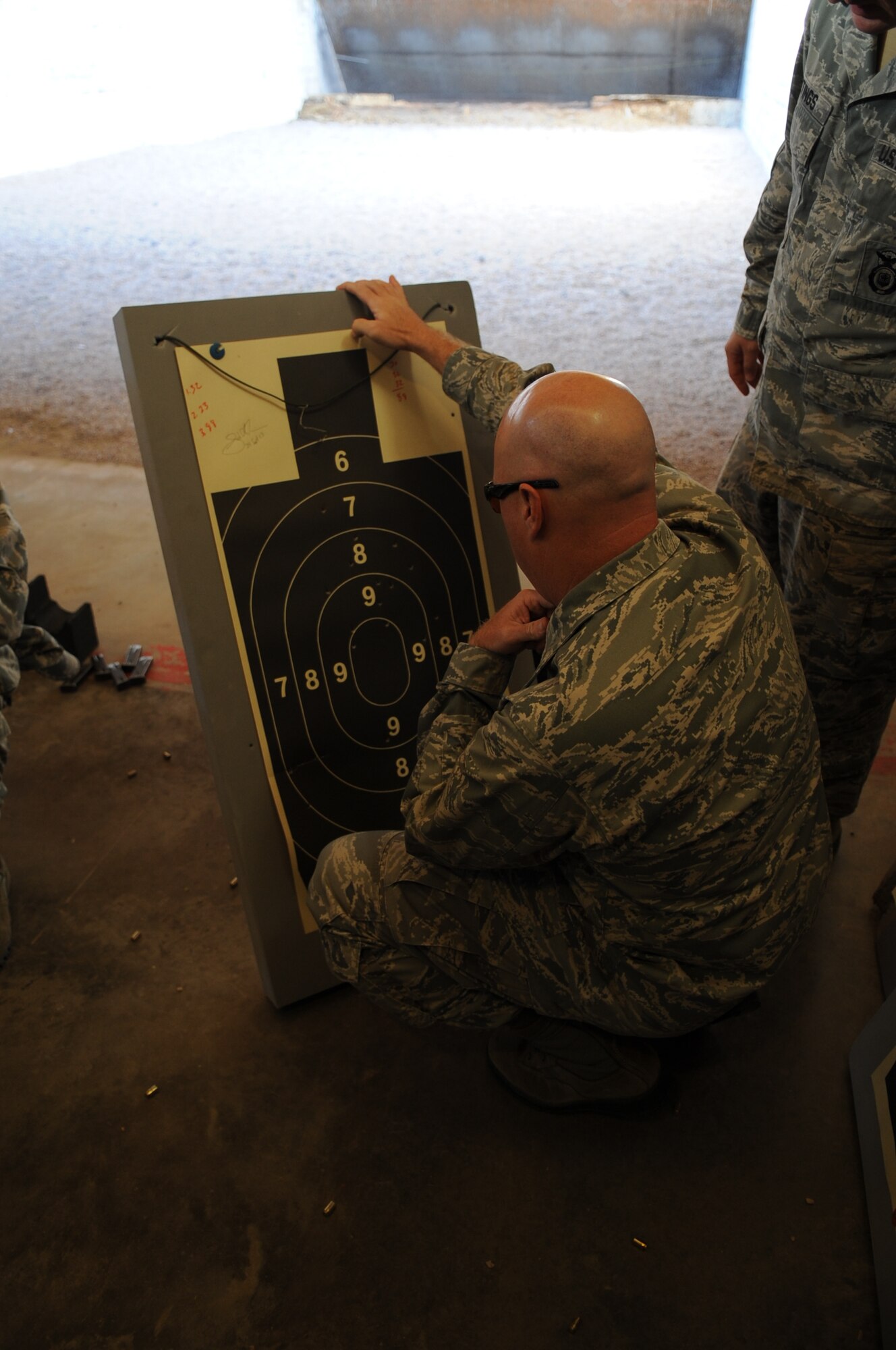 U.S. Air Force Lt. Col. Justin Lemire, 436th Training Squadron commander, looks over his shooting target, Sept. 24, 2013, at the gun range on Dyess Air Force Base, Texas. Some of Dyess’ commanders competed in a friendly shooting competition as part of the Security Forces Defenders Challenge. The Defenders Challenge included an obstacle course, 3 mile run, land navigation competition and an active shooter competition that was held to honor fallen Airmen. (U.S. Air Force photo by Senior Airman Shannon Hall/Released)