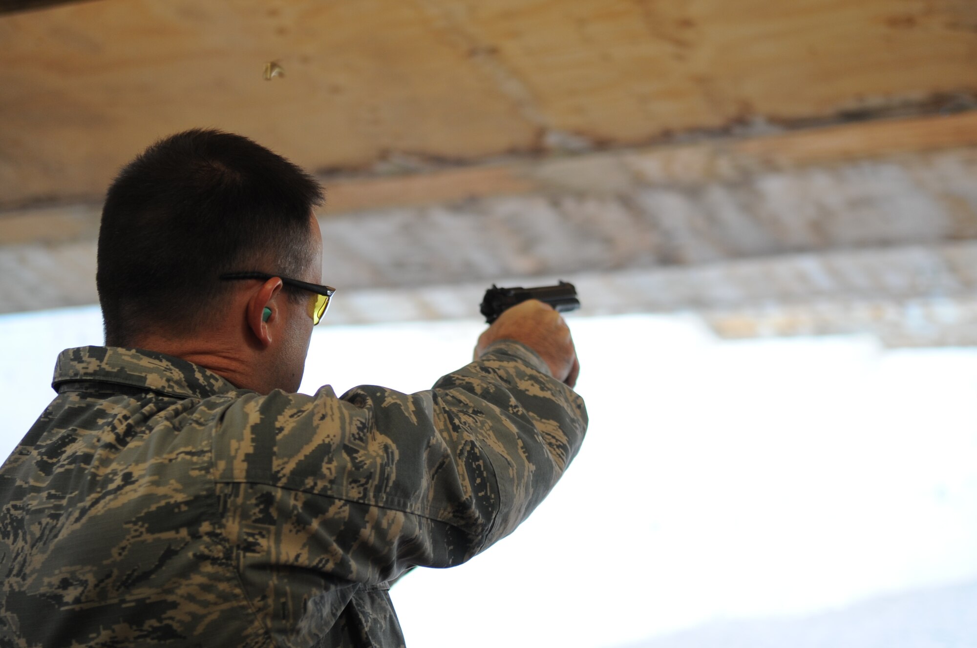 U.S. Air Force Col. Brian Yates, 7th Mission Support Group commander, shoots an M-9, Sept. 24, 2013 at the gun range at Dyess Air Force Base, Texas.  Col. Yates participated in a shooting competition with other Dyess commanders as part of the Security Forces Defenders Challenge. Other events that took place during the challenge included an obstacle course, a memorial run, land navigation competition and an active shooter competition. (U.S. Air Force photo by Senior Airman Shannon Hall/Released)