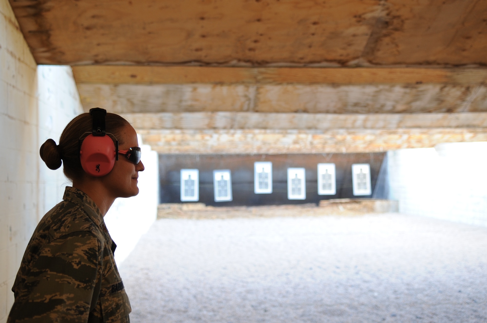 U.S. Air Force Maj. Sarah Babbit, 7th Security Forces Squadron commander, stands in front of her shooting target, Sept. 24, 2013 at the gun range at Dyess Air Force Base, Texas.  Some of Dyess’ commanders competed in a friendly shooting competition as part of the Security Forces Defenders Challenge. The Defenders Challenge is a Memorial to honor the fallen Airmen who have paid the ultimate sacrifice in the War on Terror. (U.S. Air Force photo by Senior Airman Shannon Hall/Released)