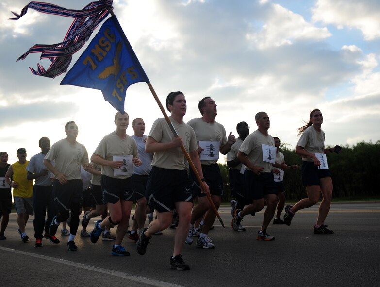 Airmen from the 7th Security Forces squadron participate in a memorial run Sept. 27, 2013, at Dyess Air force Base, Texas. All week long, the 7th SFS participated in events for a Defender’s Challenge. The Defender’s Challenge is a memorial to honor fallen defenders who have paid the ultimate sacrifice in the War on Terror. (U.S. Air Force photo by Senior Airman Kia Atkins/Released)