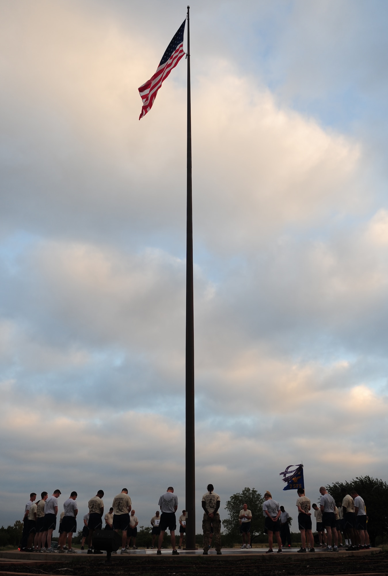 Airmen from the 7th Security Forces Squadron encircle the flag pole before a memorial run Sept. 27, 2013, at Dyess Air Force Base, Texas. The run was the final event for Defender’s Challenge week. (U.S. Air Force photo by Senior Airman Kia Atkins/Released)