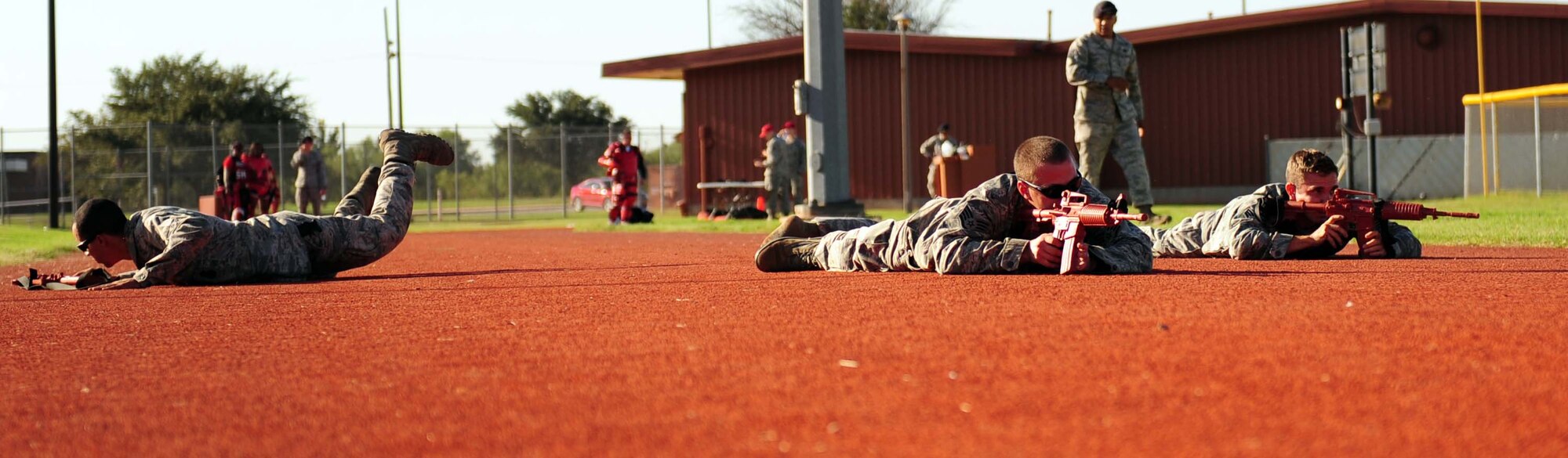 Airmen from the 7th Security Forces Squadron lay on a running track after being told a simulated enemy attack was inbound during the obstacle course portion of Defender’s Challenge week Sept. 25, 2013, at Dyess Air Force Base, Texas. The purpose of the obstacle course was to promote teamwork and to assess 7th SFS Airmen’s ability to work together. (U.S. Air Force photo by Senior Airman Kia Atkins/Released)