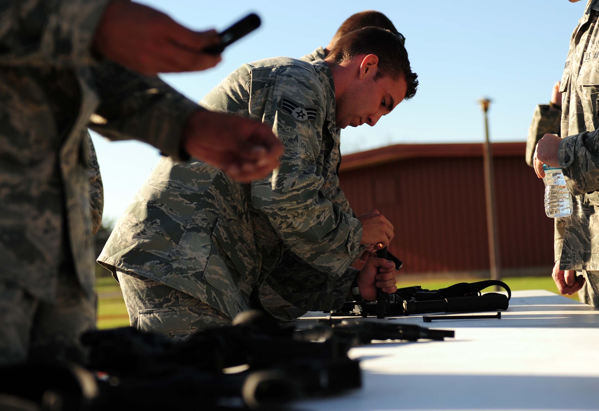 Airmen from the 7th Security Forces Squadron disassemble weapons during the obstacle course portion of a Defender’s Challenge week Sept. 25, 2013, at Dyess Air Force Base, Texas. The Defender’s Challenge is a memorial to honor fallen defenders who have paid the ultimate sacrifice in the War on Terror. (U.S. Air Force photo by Senior Airman Kia Atkins/Released)