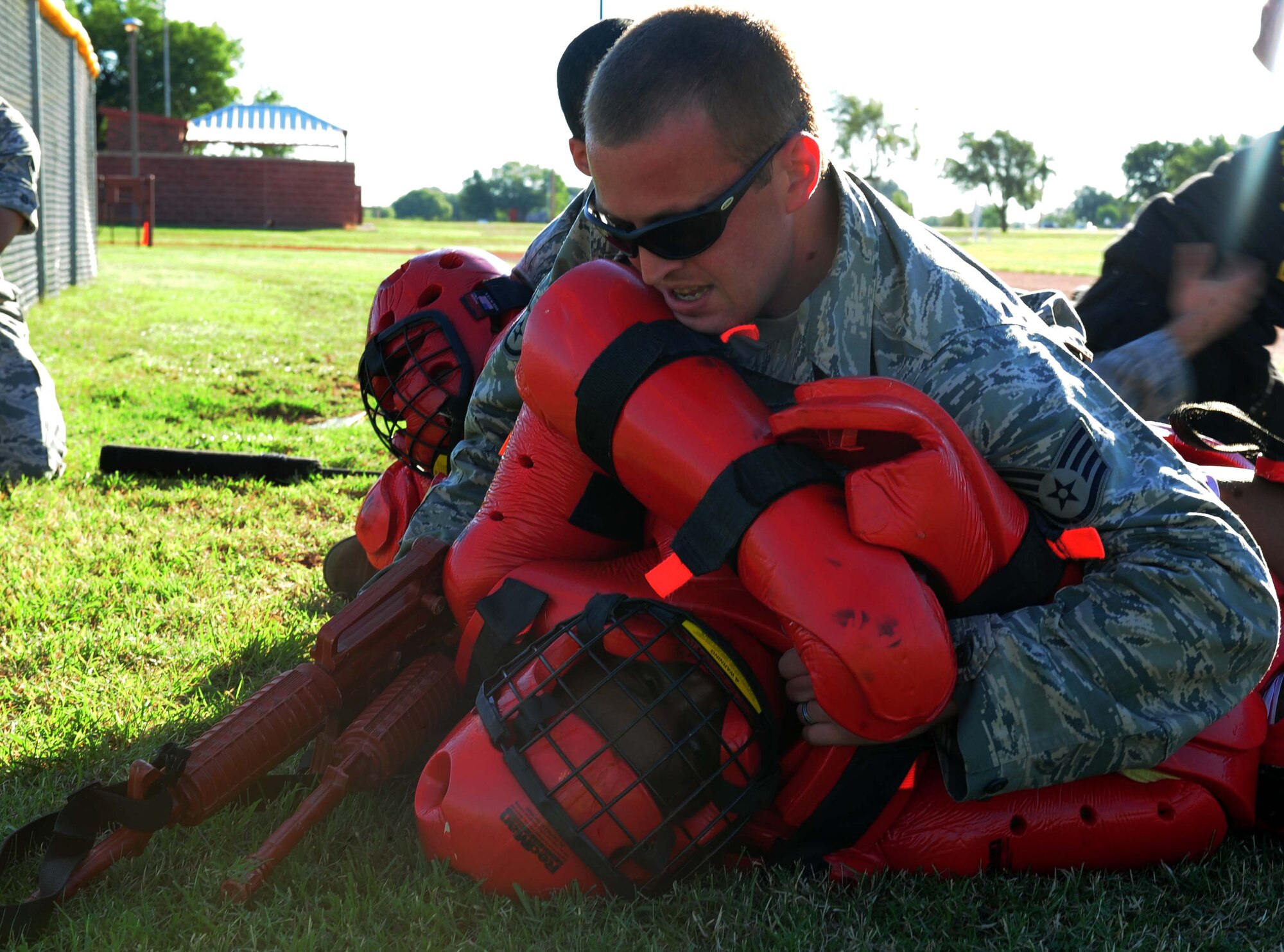 U.S. Air Force Staff Sgt. Travis Nygaard, 7th Security Forces Squadron base defense operations center controller, holds down a “bad guy” during the obstacle course portion of Defender’s Challenge week Sept. 25, 2013, at Dyess Air Force Base, Texas. During Defender’s Challenge week, 7th SFS Airmen participated in a land navigation competition, the Department of Defense top shot Excellence in Competition shooting competition, an obstacle course, an active shooter exercise and a memorial run. (U.S. Air Force photo by Senior Airman Kia Atkins/Released)