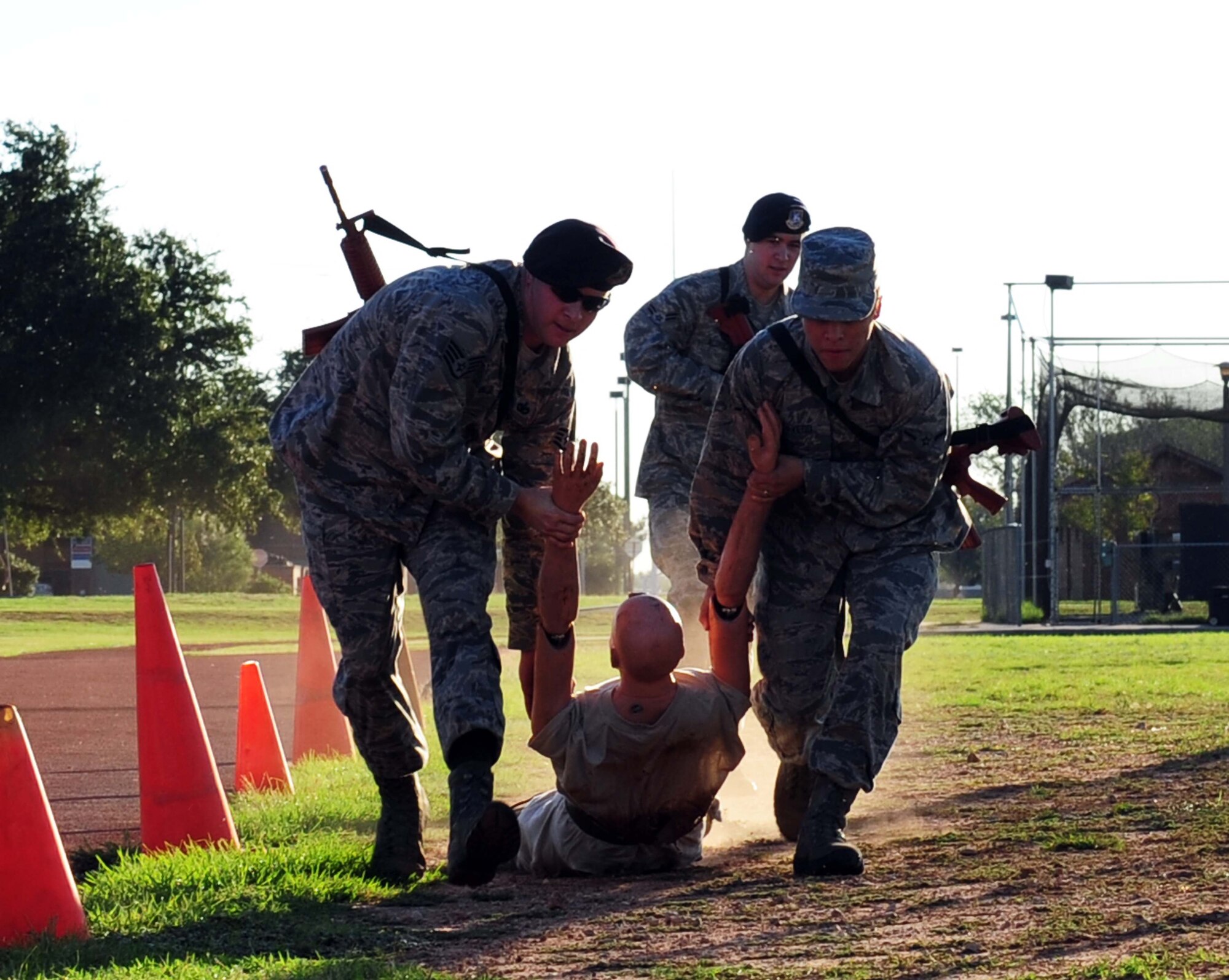 Members of the 7th Security Forces Squadron drag a dummy during the obstacle course portion of a Defender’s Challenge week Sept. 25, 2013, at Dyess Air Force Base, Texas. The obstacle course was one of five challenges held throughout the week. (U.S. Air Force photo by Senior Airman Kia Atkins/Released)