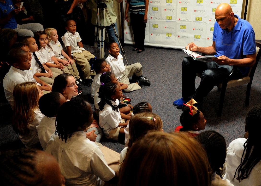 Kareem Abdul-Jabbar reads to a group of children during a Reading is Fundamental event at the Youth Center on Joint Base Andrews, Md., Oct. 1, 2013. Jabbar attended the event hosted by Joint Base Andrews and the RIF organization to help encourage and motivate children to become life-long readers. Jabbar, author and the current leading scorer in the National Basketball Association's history, read to the children. Afterwords, each child went home with books by Jabbar along with other books and prizes. (U.S. Air Force photo/ Staff Sgt. Nichelle Anderson)