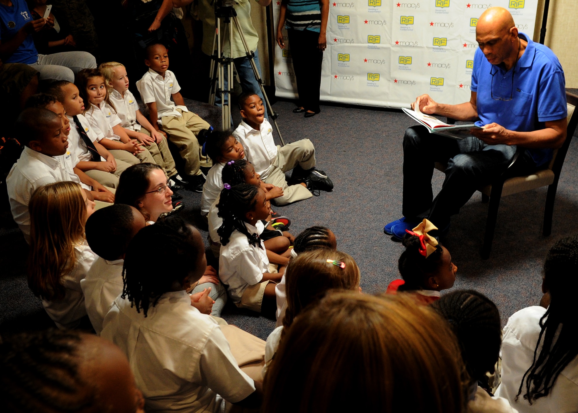 Kareem Abdul-Jabbar reads to a group of children during a Reading is Fundamental event at the Youth Center on Joint Base Andrews, Md., Oct. 1, 2013. Jabbar attended the event hosted by Joint Base Andrews and the RIF organization to help encourage and motivate children to become life-long readers. Jabbar, author and the current leading scorer in the National Basketball Association's history, read to the children. Afterwords, each child went home with books by Jabbar along with other books and prizes. (U.S. Air Force photo/ Staff Sgt. Nichelle Anderson)