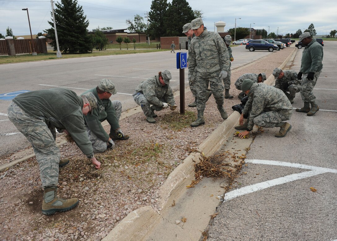 Airmen from the 28th Communication Squadron participate in a base-wide clean up at Ellsworth Air Force Base, S.D. Sept. 27, 2013. Throughout the day, Ellsworth Airmen played their role in cleaning the base by removing trash, leaves and weeds from parking lots, parks, lakes and other facilities. (U.S. Air Force photo by Airman 1st Class Rebecca Imwalle/Released)