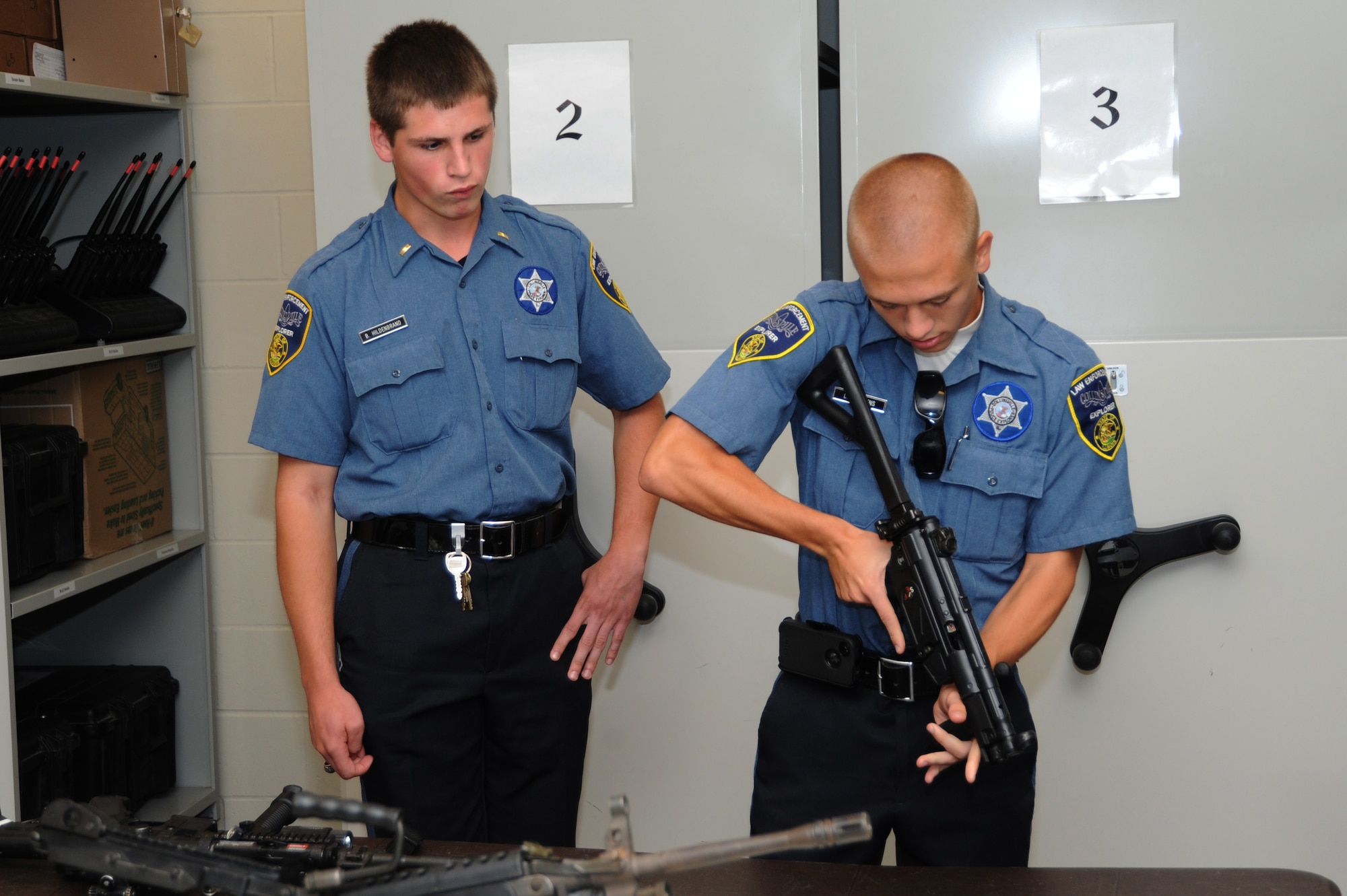 Two explorers from the Collinsville Township look at weapons at the Security Forces Armory Sept. 25, 2013. The explorers are 14-20 young adults who are interested in going into a career in law enforcement. (U.S. Air Force photo/Airman Megan Friedl)