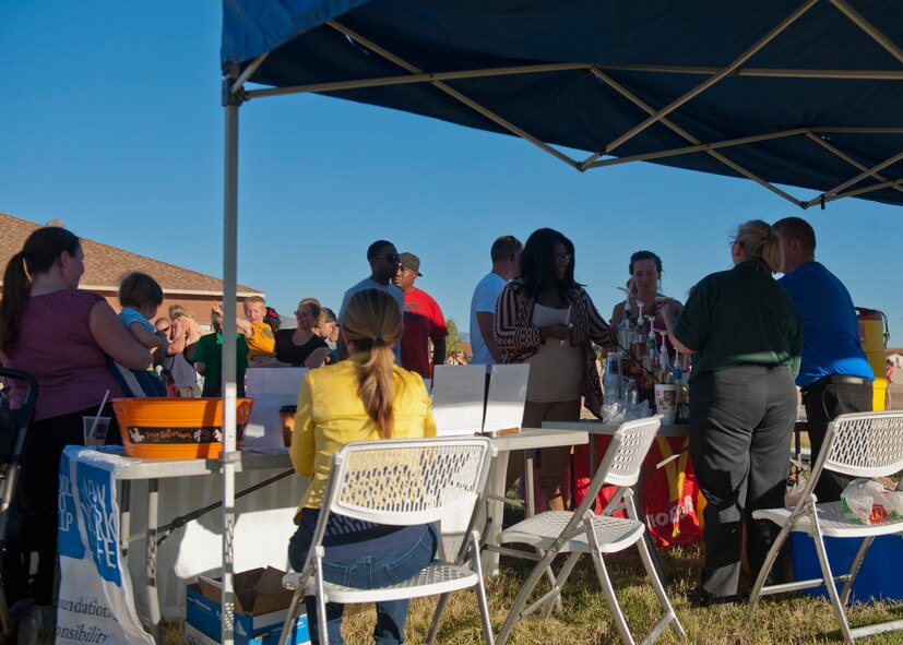 Members of Team Holloman and Alamogordo residents participate in the annual National Night Out event hosted by Soaring Heights Communities at Holloman Air Force Base, N.M., Oct. 1. During the event, local vendors offered free food and beverages. Soaring Heights also set up activities for children and raffled off prizes. (U.S. Air Force photo by Airman 1st Class Aaron Montoya/Released)