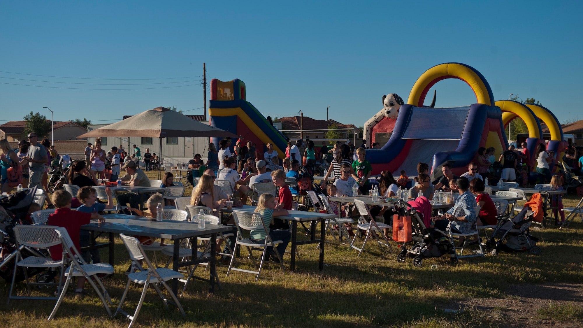 Members of Team Holloman and Alamogordo residents await the raffle portion of the evening at the annual National Night Out event hosted by Soaring Heights Communities at Holloman Air Force Base, N.M., Oct. 1. During the event, local vendors offered free food and beverages. Soaring Heights also set up activities for children and raffled off prizes. (U.S. Air Force photo by Airman 1st Class Aaron Montoya/Released)