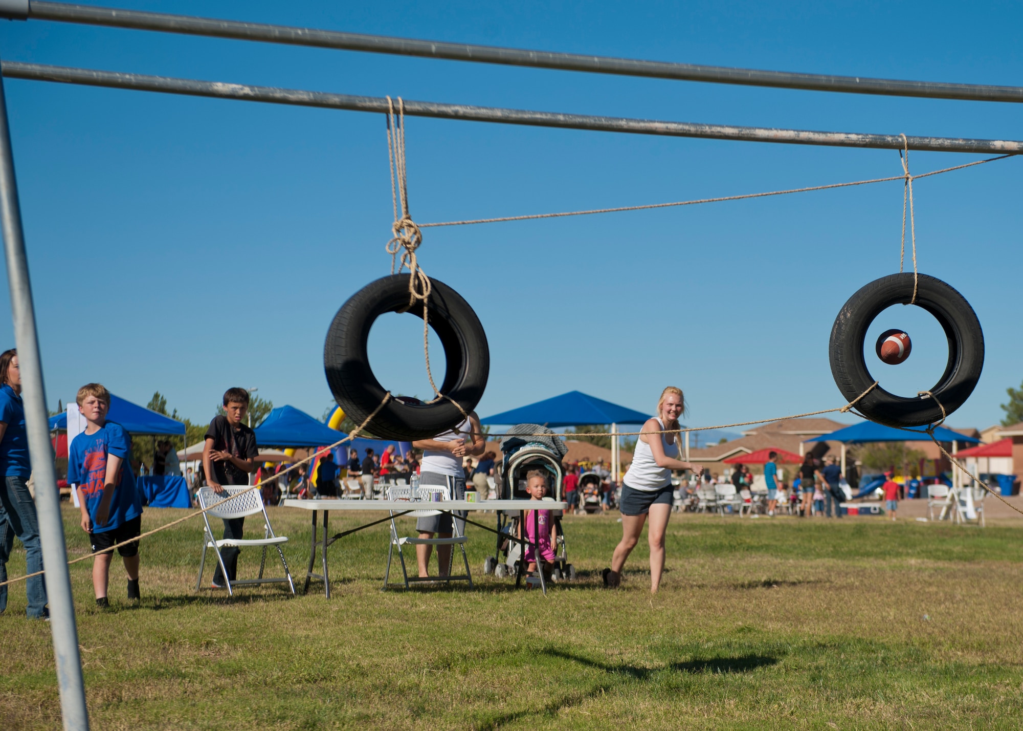 Members of Team Holloman and Alamogordo residents participate in various games at the annual National Night Out event hosted by Soaring Heights Communities at Holloman Air Force Base, N.M., Oct. 1. During the event, local vendors offered free food and beverages. Soaring Heights also set up activities for children and raffled off prizes. (U.S. Air Force photo by Airman 1st Class Aaron Montoya/Released)