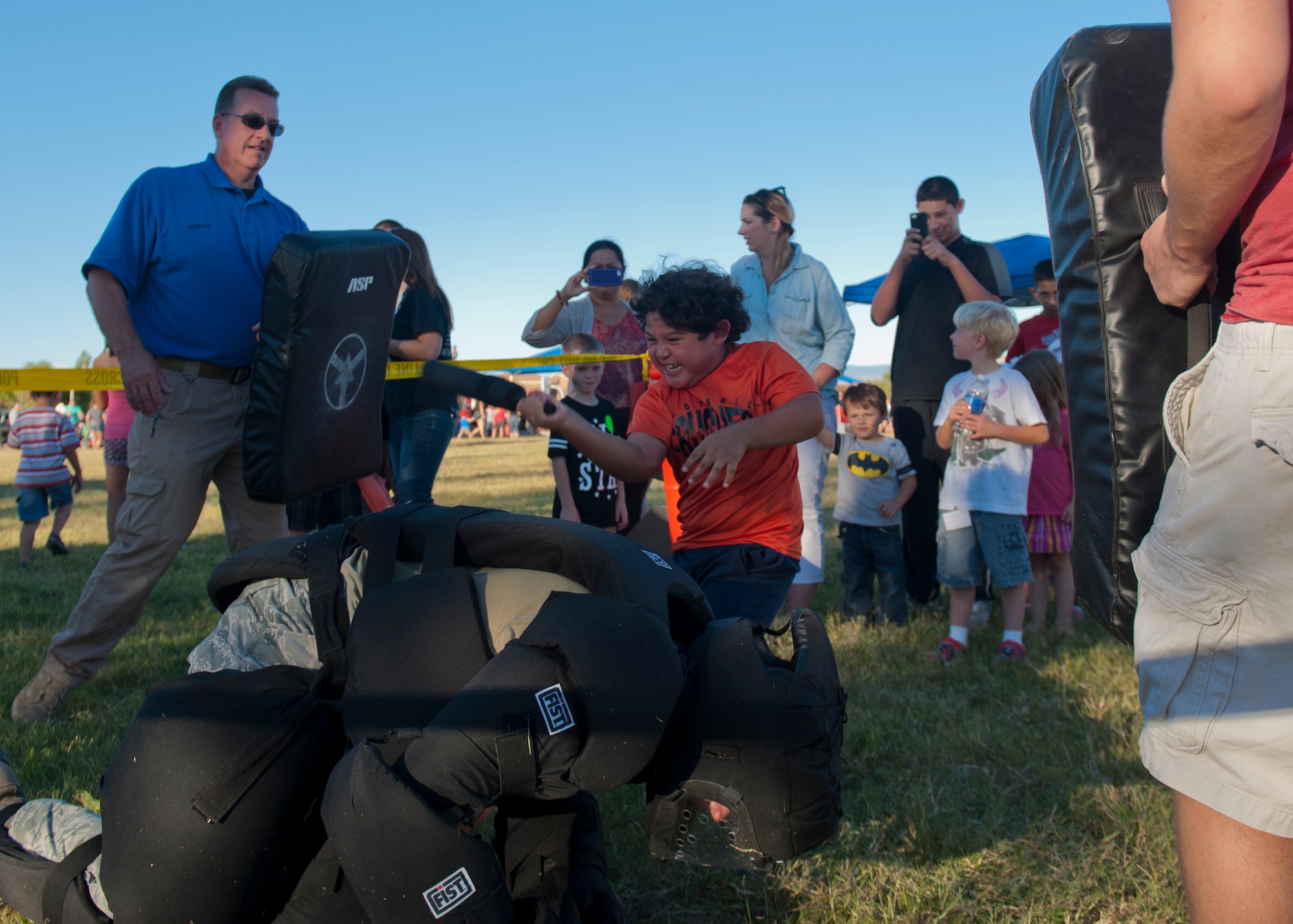 The 49th Security Forces Squadron Community Police demonstrate self-defense techniques to Team Holloman dependents at the annual National Night Out event hosted by Soaring Heights Communities at Holloman Air Force Base, N.M., Oct 1. The Otero County Sheriffs Department, Alamogordo Department of Public Safety and the 49th SFS Community Police attended the event to showcase their support in the fight for a safer community. (U.S. Air Force photo by Airman 1st Class Aaron Montoya/Released)