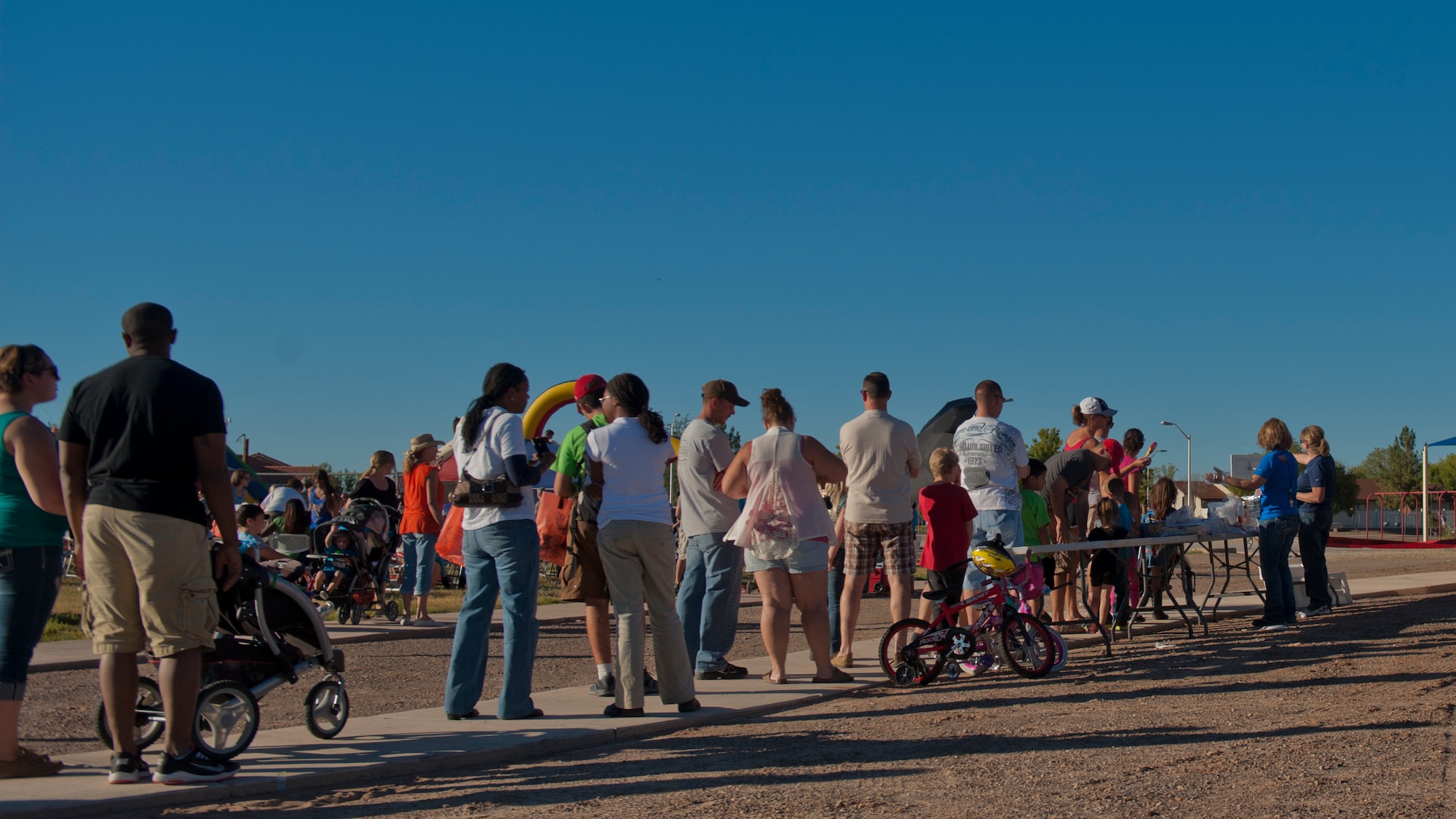 Members of Team Holloman and Alamogordo residents participate in the annual National Night Out event hosted by Soaring Heights Communities at Holloman Air Force Base, N.M., Oct. 1. During the event, local vendors offered free food and beverages. Soaring Heights also set up activities for children and raffled off prizes. (U.S. Air Force photo by Airman 1st Class Aaron Montoya/Released)