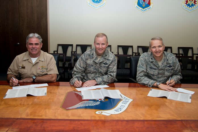 (From left to right) U.S. Navy Capt. Timothy Sparks, Joint Base Charleston deputy commander, Col. Jeffrey DeVore, Joint Base Charleston commander, and Col. Darren Hartford, 437th Airlift Wing commander, smile as they sign their 2013 Combined Federal Campaign donation slips Sept. 30, 2013 at Joint Base Charleston, S.C.  The CFC is currently underway for JB Charleston until Nov. 8 and is designed to give all federal employees an opportunity to donate to eligible non-profit organizations. (U.S. Air Force photo/Tech. Sgt. Rasheen Douglas)