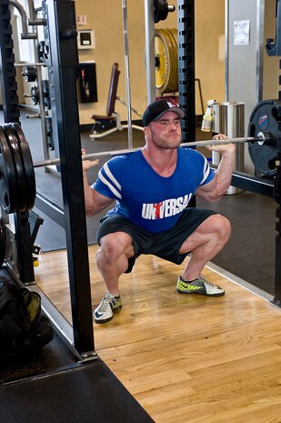 Roman Fritz, professional body builder from Germany and Universal Nutrition sponsored athlete, performs squats at the Warrior Fitness Center Sept. 26, 2013, at Nellis Air Force Base, Nev. Universal Nutrition sponsors body building athletes from all over the world. The athletes worked out with Airmen and gave them fitness advice. (U.S. Air Force photo by Senior Airman Matthew Lancaster)