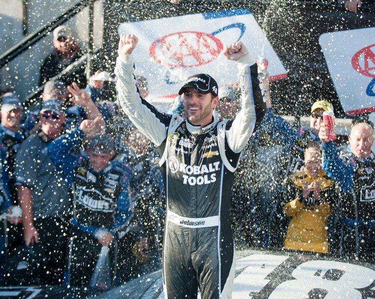 Jimmie Johnson, driver of the No. 48 Kobalt/Lowe’s Chevy, celebrates his win in victory lane after winning the AAA 400 Sept. 29, 2013, at Dover International Speedway in Dover, Del. Johnson, who started the race in eighth place, won at Dover for a record-breaking eighth time, surpassing NASCAR Hall of Famers Richard Petty and Bobby Allison. (U.S. Air Force photo/Senior Airman Jared Duhon)