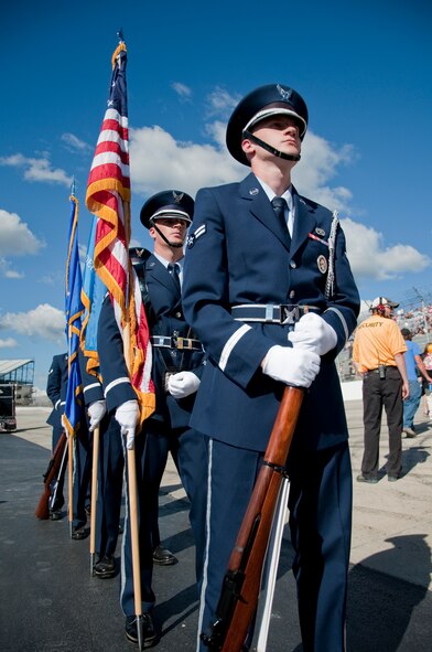 Team Dover honor guard members stand at attention during pre-race ceremonies before the start of the 5-Hour Energy 200 Sept. 28, 2013, at Dover International Speedway in Dover, Del. The honor guard presented the colors during the National Anthem. (U.S. Air Force photo/Senior Airman Jared Duhon)