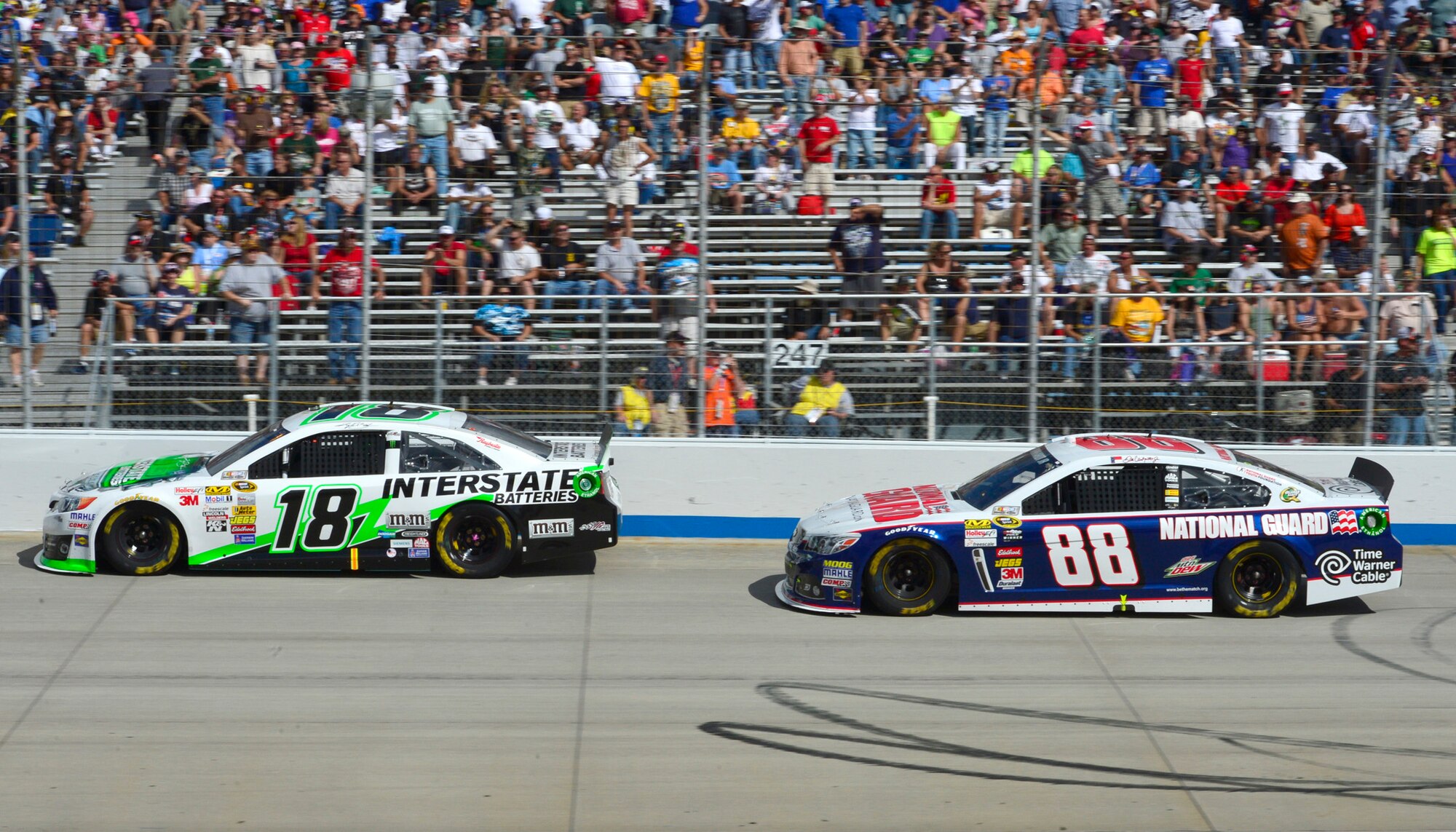 Kyle Busch, driver of the No. 18 Interstate Batteries Toyota, and Dale Earnhardt, Jr., driver of the No. 88 National Guard Chevy, race down the front stretch during the AAA 400 Sept. 29, 2013, at Dover International Speedway in Dover, Del. Earnhardt, who started the race from the pole position, finished second, while Busch finished fifth. (U.S. Air Force photo/David Tucker)