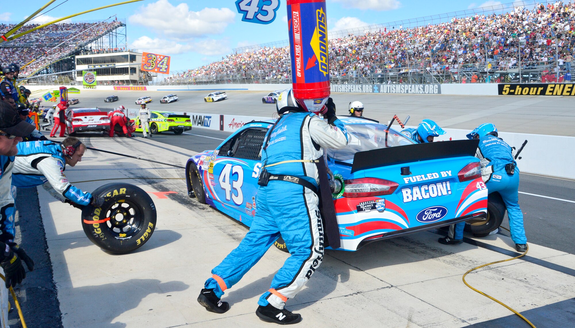 Pit crew members for Aric Almirola, driver of the No. 43 Smithfield/U.S. Air Force Ford, work on his car during the AAA 400 Sept. 29, 2013, at Dover International Speedway in Dover, Del. Almirola was pitting under a caution for debris on the track. (U.S. Air Force photo/David Tucker)