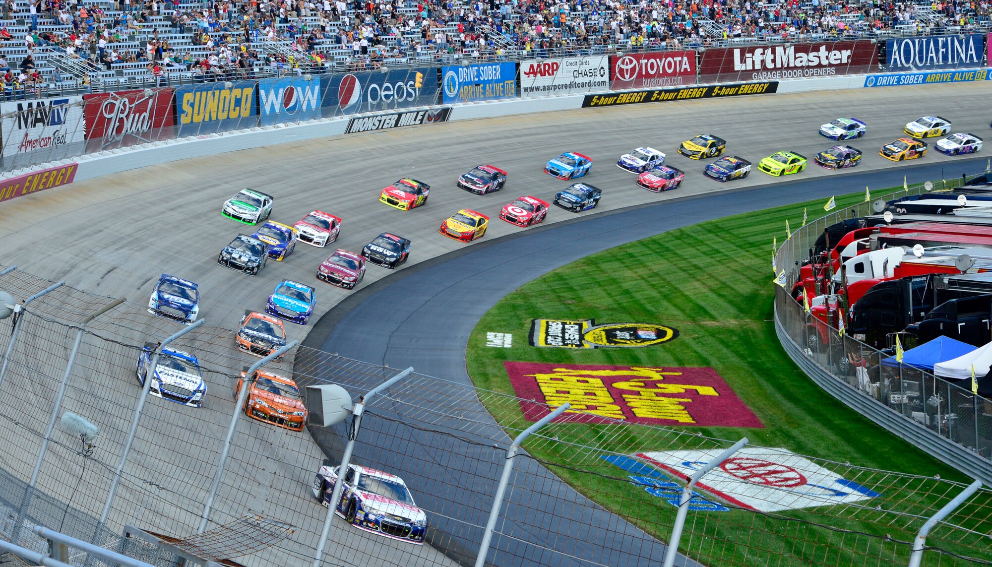 Dale Earnhardt, Jr., driver of the No. 88 National Guard Chevy, leads pack out of turn two at the start of the AAA 400 Sept. 29, 2013, at Dover International Speedway in Dover, Del. Jimmie Johnson, driver of the No. 48 Kobalt/Lowe’s Chevy won at Dover for a record-breaking eighth time. (U.S. Air Force photo/David Tucker)