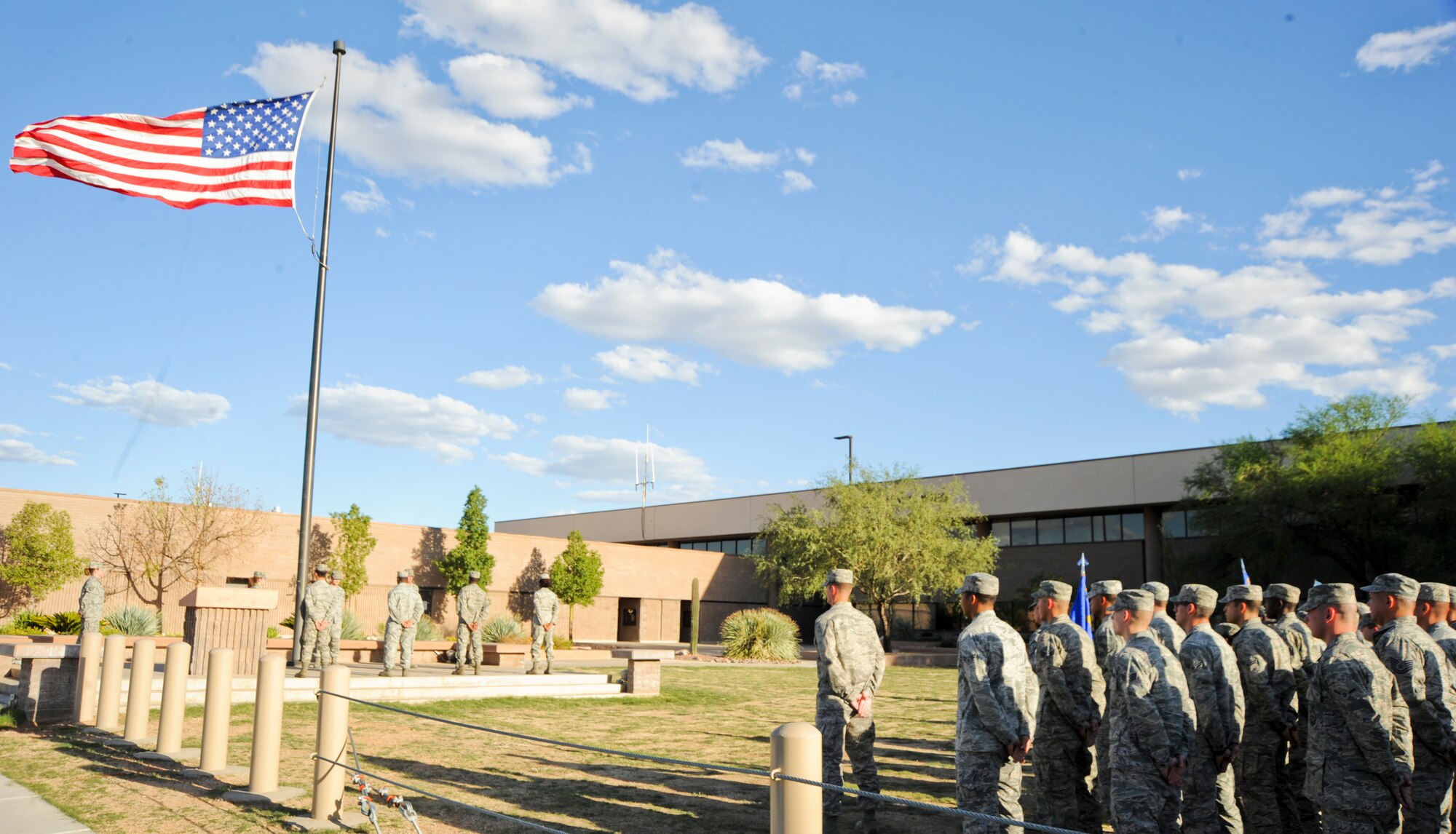 U.S. Air Force Airmen stand at ease while waiting for the 355th Mission Support Group retreat ceremony to start at Davis-Monthan Air Force Base, Ariz., Sept. 26, 2013. The retreat ceremony serves a twofold purpose. It signals the end of the official duty day and serves as a ceremony for paying respect to the flag. (U.S. Air Force photo by Senior Airman Justin Veazie/Released)