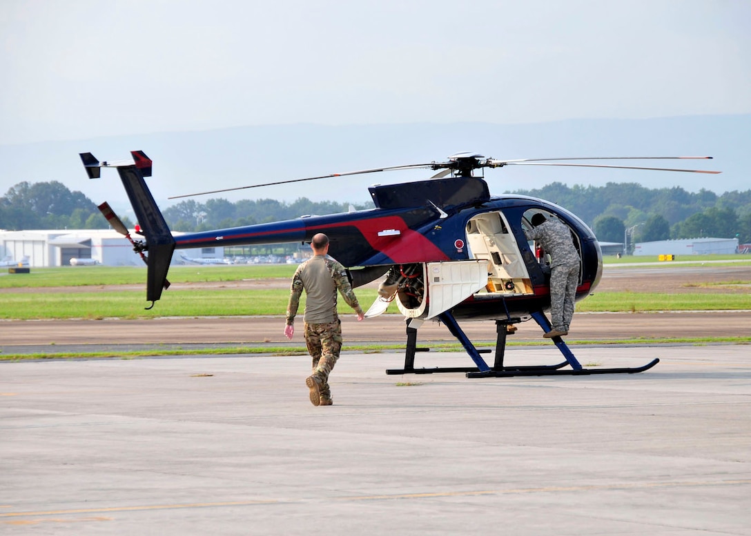 A DEA special agent and an Army National Guard pilot conduct pre-flight checks on an aircraft at McGhee Tyson Air National Guard Base, TN as part of the aviation division's ERAD program.  (U.S. Air National Guard photo illustration by Master Sgt. Kendra M. Owenby, 134 ARW Public Affairs)