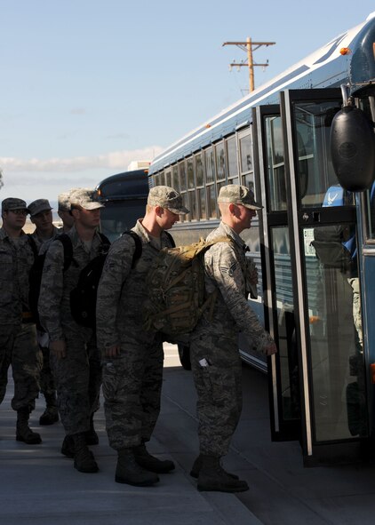 Airmen from the 37th Bomb Squadron board a bus outside the Deployment Center during a Green Flag exercise at Ellsworth Air Force Base, S.D. More than 130 Ellsworth Airmen traveled to Nellis Air Force Base, Nev., to test their ability to survive and operate in a wartime environment in preparation for future deployments. (U.S. Air Force photo by Airman 1st Class Rebecca Imwalle/Released)