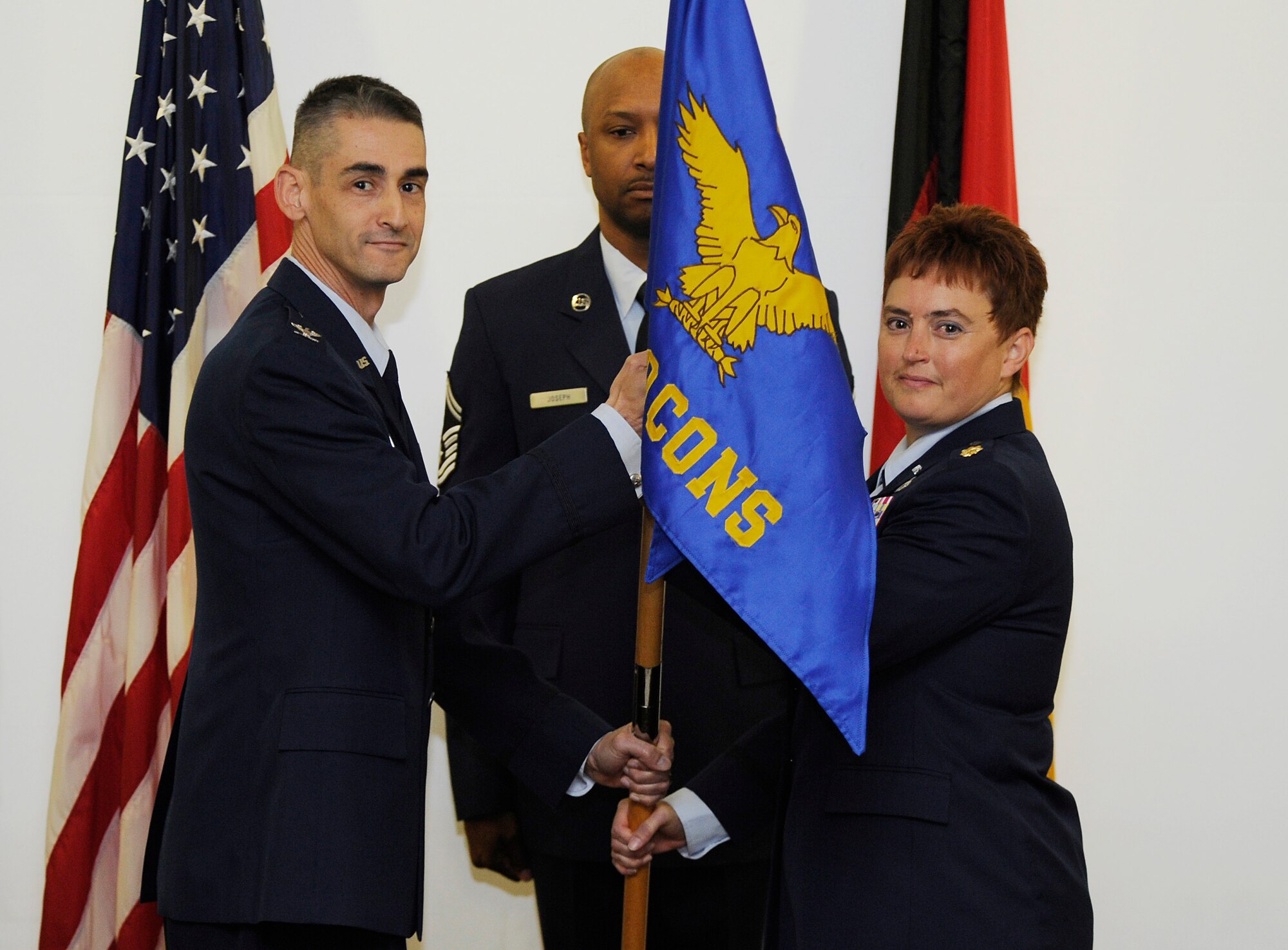 Col. Mario Troncoso, Air Force Installation Contracting Agency director, passes the guidon to Maj. Rachelle Osborn, symbolizing her taking command of the 764th Specialized Contracting Squadron during an activation ceremony at Ramstein Air Base, Germany Oct. 2, 2013. The 764th SCONS is a newly formed squadron that will provide contracting support to all of U.S. Air Forces Europe and Air Forces Africa bases for projects worth more than $2 million or if allocated money will be used at multiple locations. Osborn was previously in charge of the specialized contracting flight under the 700th Contracting Squadron. (U.S. Air Force photo/ Staff Sgt. Ryan Crane)